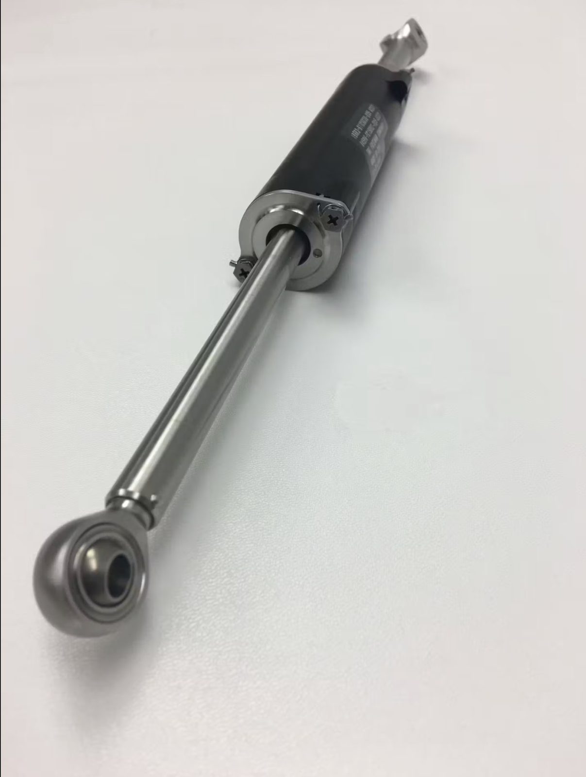 Rate control device with cylinder body, polished rod, and spherical rod-end bearing.